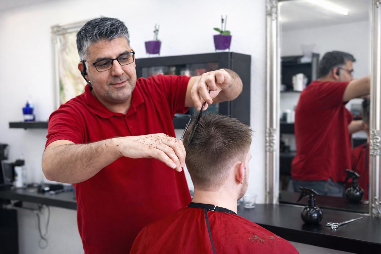 Abdul klipper en kunde med saks i Tiptop Klip i Aarhus